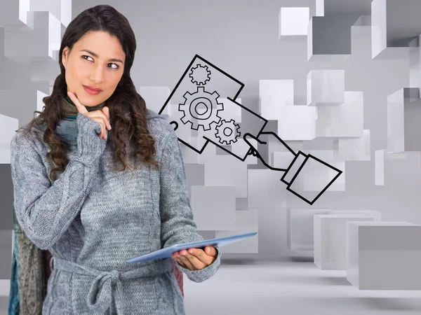 Pensive model wearing winter clothes holding her tablet — Stock Photo, Image