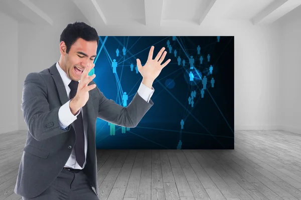 Composite image of excited businessman catching — Stock Photo, Image