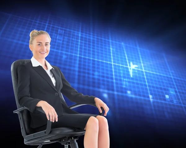 Composite image of businesswoman sitting on swivel chair in blac — Stock Photo, Image
