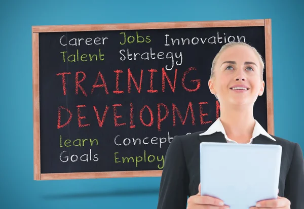 Composite image of businesswoman holding tablet — Stock Photo, Image