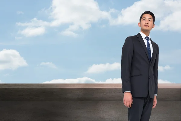 Composite image of serious asian businessman — Stock Photo, Image