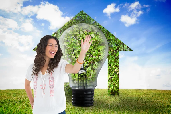 Composite image of cheerful attractive brunette smiling while greeting — Stock Photo, Image