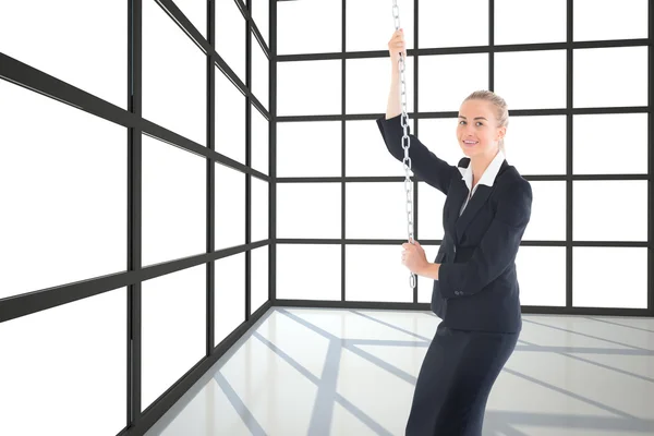 Composite image of businesswoman pulling a chain — Stock Photo, Image