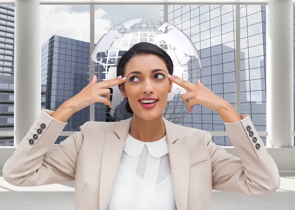 Composite image of confident young businesswoman pointing her head with her fingers — Stock Photo, Image