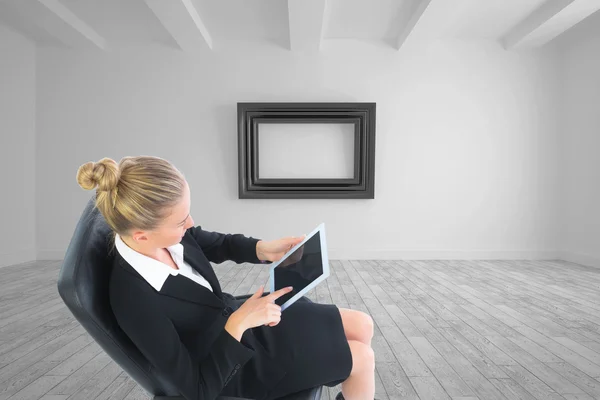 Composite image of businesswoman sitting on swivel chair with tablet — Stock Photo, Image