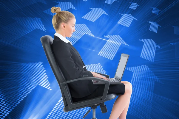 Composite image of businesswoman sitting on swivel chair with laptop — Stock Photo, Image