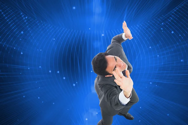 Composite image of unsmiling businessman with arms raised — Stock Photo, Image