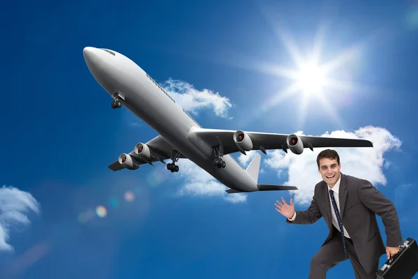Composite image of cheerful businessman in a hury — Stock Photo, Image