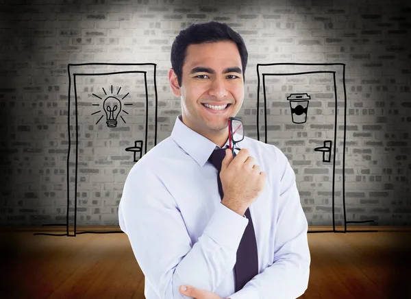 Composite image of smiling businessman holding glasses — Stock Photo, Image