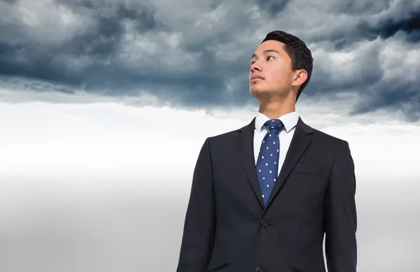 Composite image of serious asian businessman — Stock Photo, Image