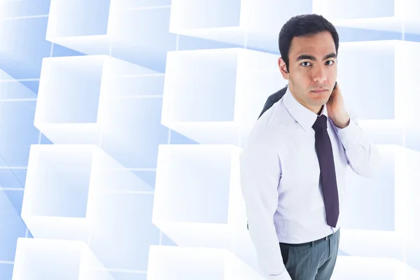 Composite image of unsmiling businessman standing — Stock Photo, Image