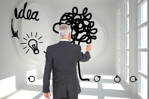 Composite image of rear view of businessman standing and writing — Stock Photo, Image