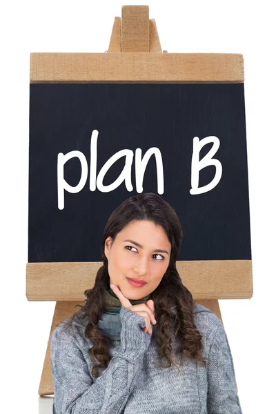 Pensive model wearing winter clothes holding her tablet — Stock Photo, Image