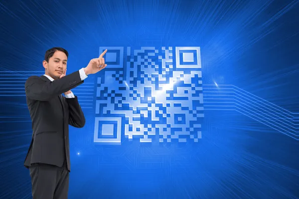 Composite image of thoughtful asian businessman pointing — Stock Photo, Image