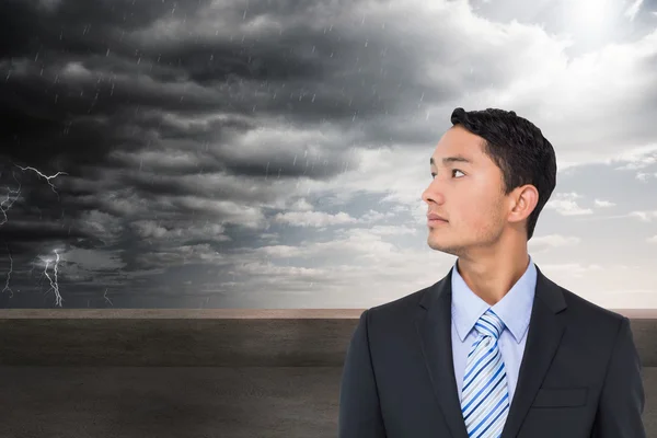 Composite image of serious asian businessman — Stock Photo, Image