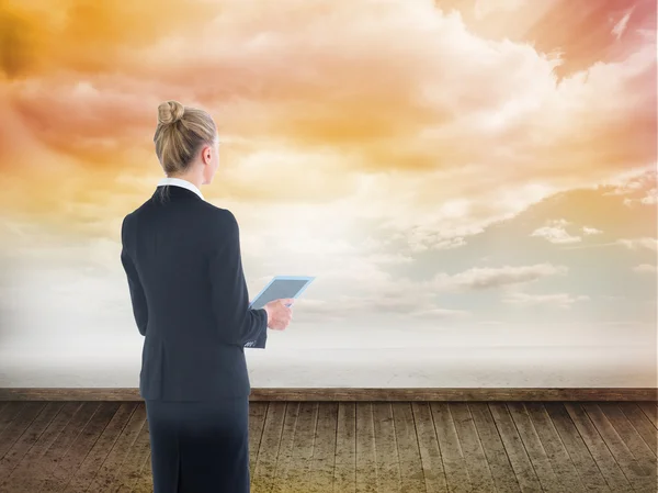 Composite image of businesswoman holding new tablet — Stock Photo, Image