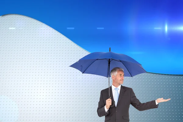 Imagem composta de homem de negócios feliz segurando guarda-chuva — Fotografia de Stock