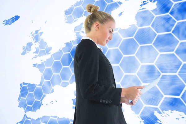 Composite image of businesswoman holding tablet — Stock Photo, Image