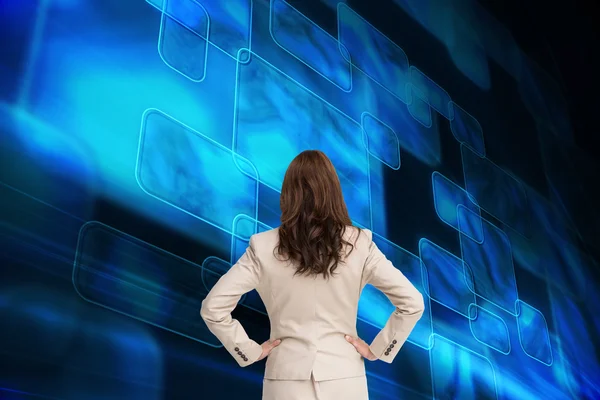 Composite image of businesswoman standing back to camera — Stock Photo, Image