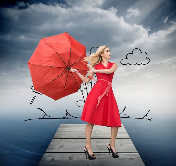 Beautiful woman posing with a broken umbrella — Stock Photo, Image