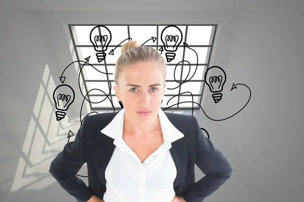 Composite image of businesswoman standing with hands on hips — Stock Photo, Image