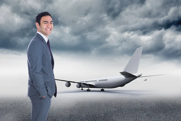 Composite image of smiling businessman standing — Stock Photo, Image