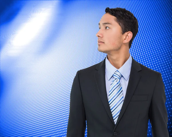 Composite image of serious asian businessman — Stock Photo, Image