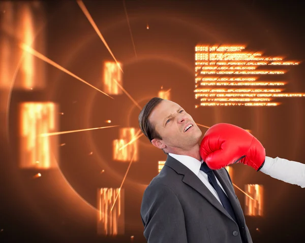 Businesswoman hitting colleague with her boxing gloves — Stock Photo, Image