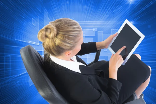 Composite image of businesswoman sitting on swivel chair with ta — Stock Photo, Image