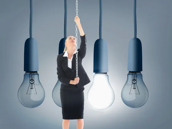 Composite image of businesswoman pulling a chain — Stock Photo, Image