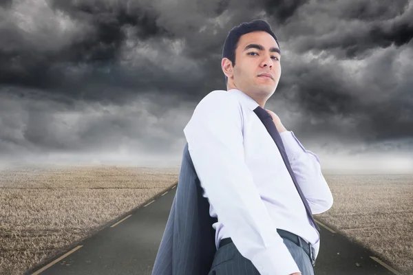 Composite image of unsmiling businessman standing — Stock Photo, Image