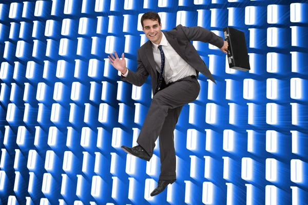 Samengestelde afbeelding van lachende zakenman in een hury — Stockfoto