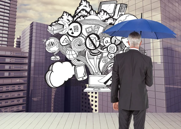 Composite image of businessman holding umbrella — Stock Photo, Image