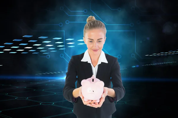 Samengestelde afbeelding van zakenvrouw houden van roze piggy bank — Stockfoto