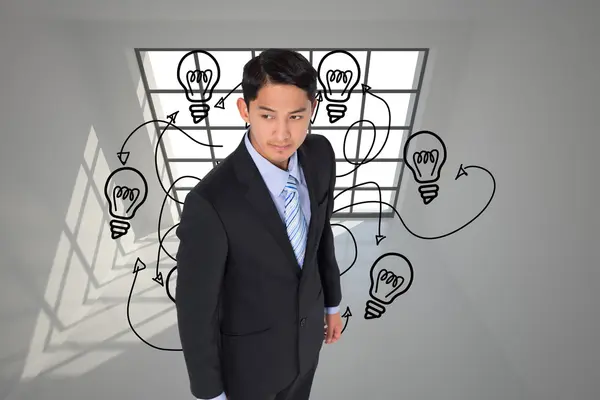 Composite image of serious asian businessman — Stock Photo, Image