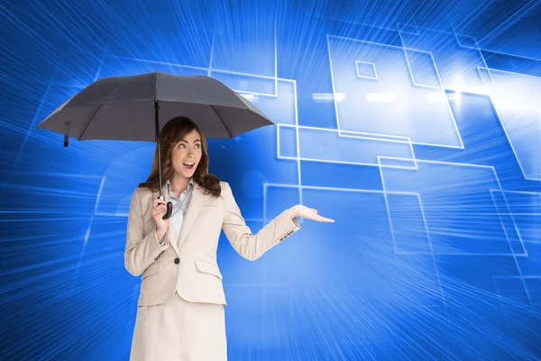 Composite image of elegant businesswoman holding black umbrella — Stock Photo, Image