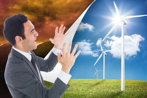 Composite image of excited businessman with arms raised — Stock Photo, Image