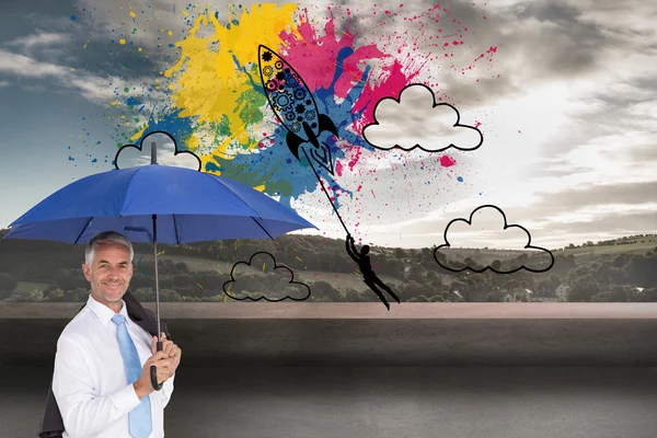 Composite image of businessman holding umbrella smiling at camera — Stock Photo, Image