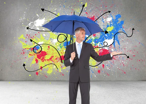 Businessman holding umbrella — Stock Photo, Image