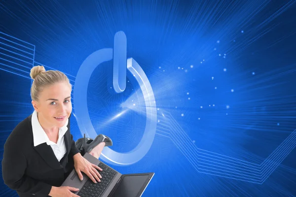 Composite image of businesswoman using laptop — Stock Photo, Image