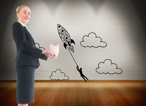 Composite image of businesswoman holding pink piggy bank — Stock Photo, Image