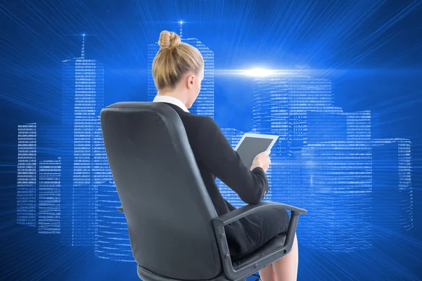 Composite image of businesswoman sitting on swivel chair with tablet — Stock Photo, Image