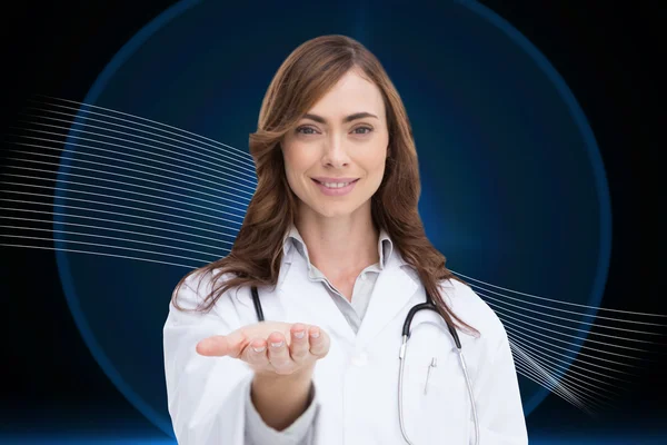 Composite image of portrait of female nurse holding out open palm — Stock Photo, Image