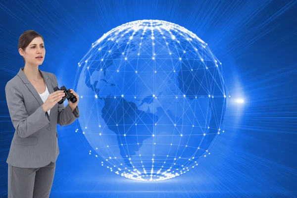 Curious young businesswoman with binoculars — Stock Photo, Image