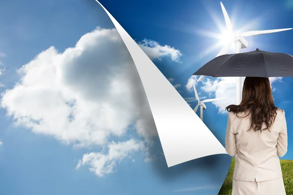 Composite image of rear view of classy businesswoman holding umbrella — Stock Photo, Image