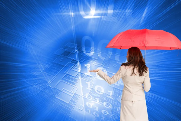 Composite image of businesswoman holding umbrella — Stock Photo, Image