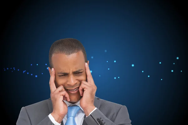 Businessman putting his fingers on his temples — Stock Photo, Image