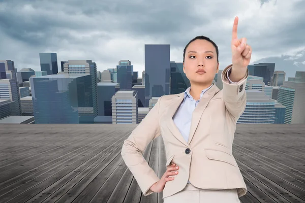 Compuesto imagen de unsmiling asiático businesswoman apuntando —  Fotos de Stock