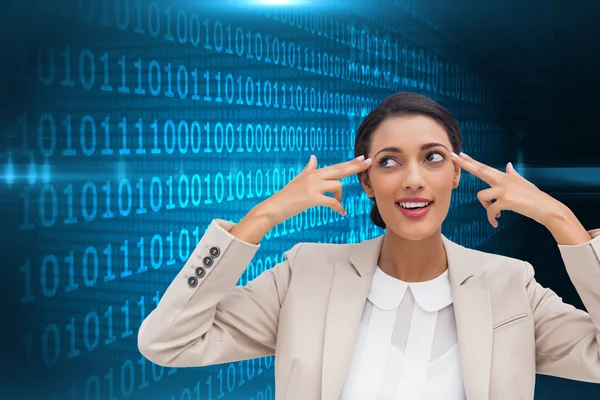 Composite image of confident young businesswoman pointing her head with her fingers — Stock Photo, Image