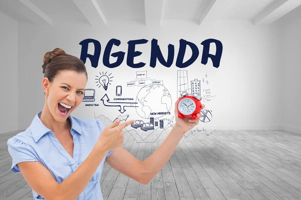 Businesswoman indicating alarm clock — Stock Photo, Image